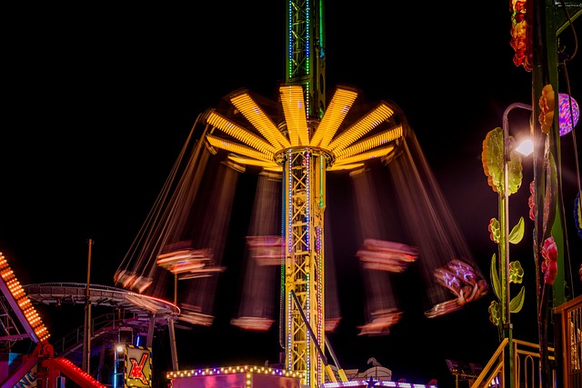 Vibrant carnival scene with illuminated rides at night